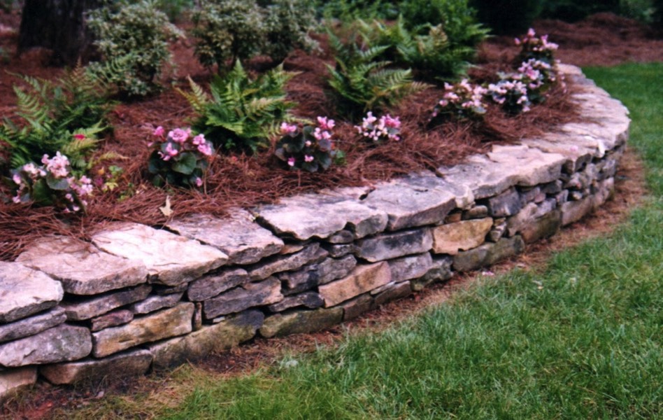 Low stone wall flower bed